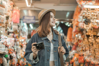 Young woman looking at market stall