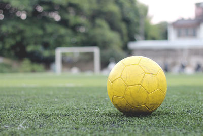 Close-up of yellow soccer ball on playing field