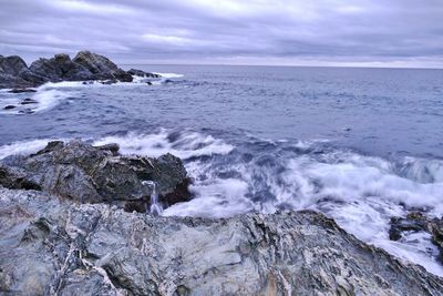 Scenic view of sea against cloudy sky