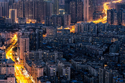 High angle view of illuminated buildings in city at night