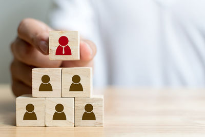 Close-up of man hand stacking toy blocks on table