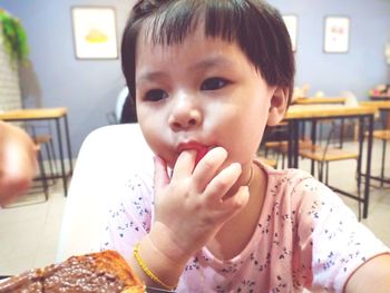 Portrait of cute baby boy looking at table