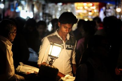 People enjoying music concert at night