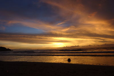 Scenic view of beach and sea against sky during sunset