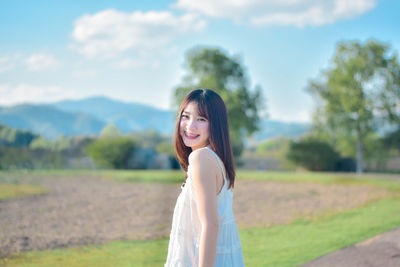 Young woman standing on field