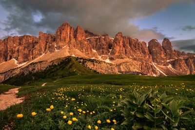 Scenic view of rocky mountains against cloudy sky