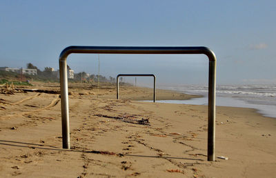 Empty seats on beach against clear sky