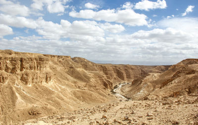 View of mountains against cloudy sky at desert