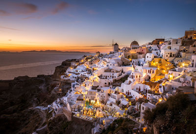 High angle view of townscape by sea against sky