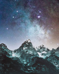 Low angle view of mountain against sky at night