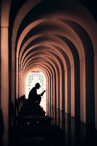 Side view of silhouette man in corridor of building