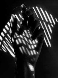 Midsection of person standing against wall