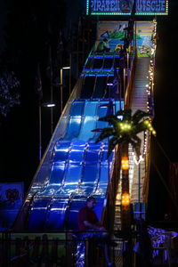 Low angle view of illuminated ferris wheel at night