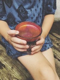 Low section of woman holding bowl