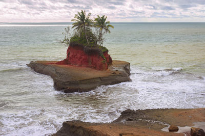 A beach with its own island in the middle of the ocean