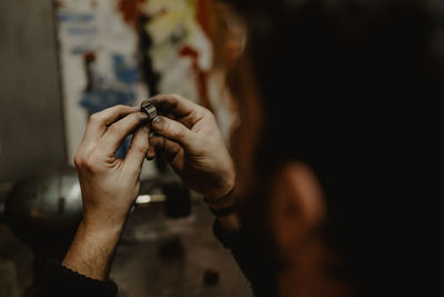 Close-up of hand holding hands outdoors