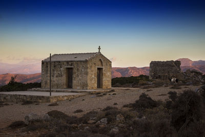 Chapel on field against sky