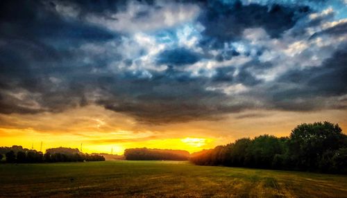 Scenic view of field against sky during sunset