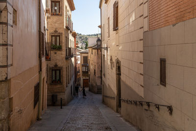 Narrow alley amidst buildings in town