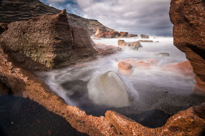 View of rocky coast against sky