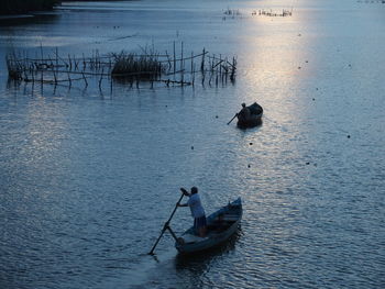 High angle view of men in boats sailing on river