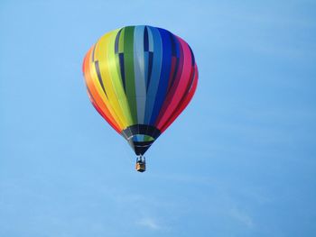 Low angle view of hot air balloon against blue sky
