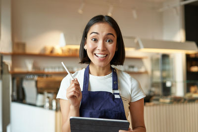 Portrait of young woman using digital tablet