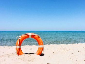 View of beach against sea against clear sky