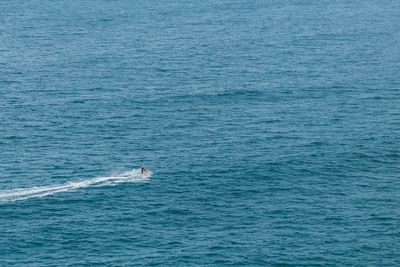 High angle view of person riding jet boat in sea