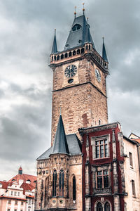 Low angle view of clock tower against sky in city