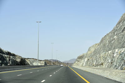 Empty road against clear sky