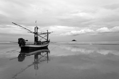 Fishing boat in sea against sky