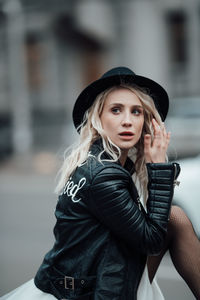 Portrait of beautiful young woman wearing hat