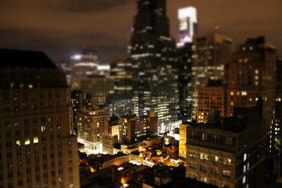 Aerial view of city lit up at night