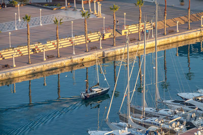 High angle view of sailboats moored at harbor