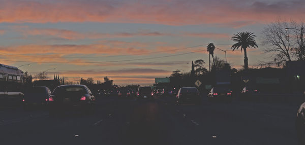 View of city street at sunset