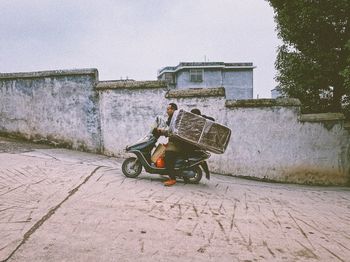 Side view of motorcycle on street against building