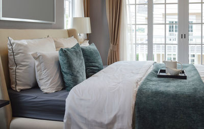 Midsection of woman relaxing on bed at home