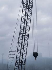Low angle view of crane bridge against sky