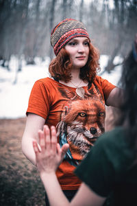 Beautiful young woman in hat during winter