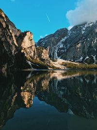 Scenic view of lake and mountains against blue sky