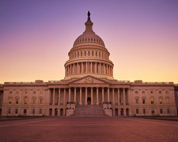 Low angle view of united states capitol against sky during sunset