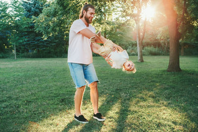 Full length of a man holding plant in park