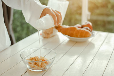 Close-up of person preparing food on table