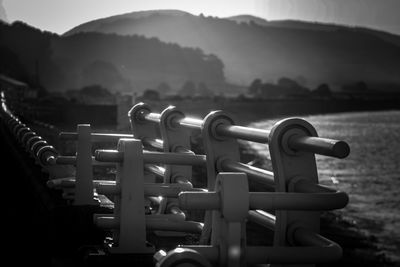 Close-up of metal railing against sky