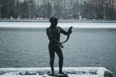 Rear view of man standing on snow