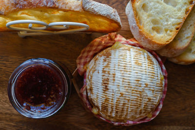 Directly above shot of camembert with jam bottle