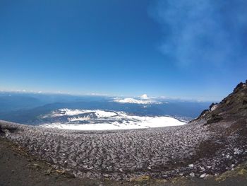 Scenic view of mountains against blue sky