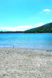 Scenic view of sea against blue sky