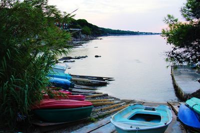 Boats moored in river against sky